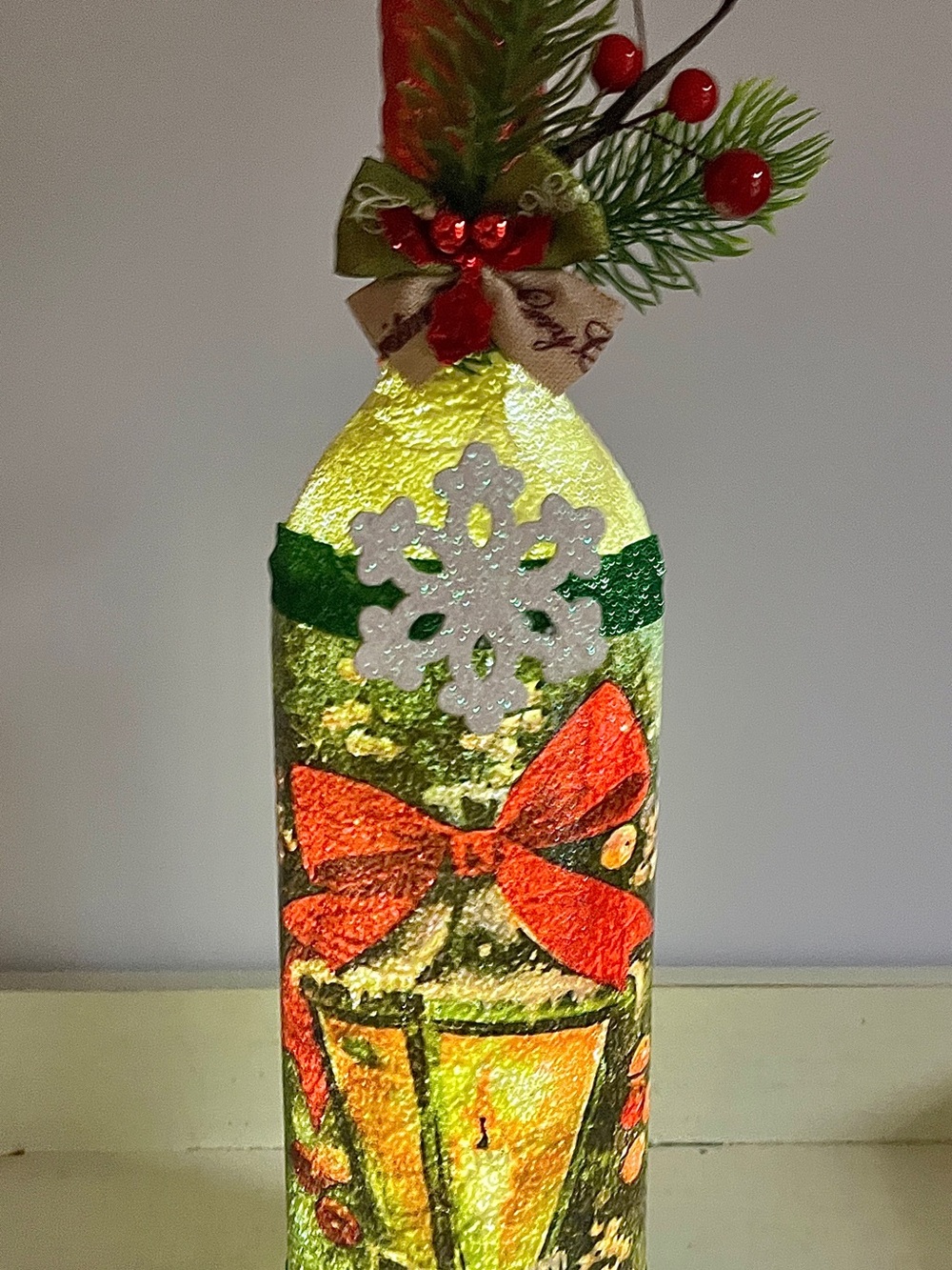Festive Lighted Holiday Bottle with Red Bow and Green Accents